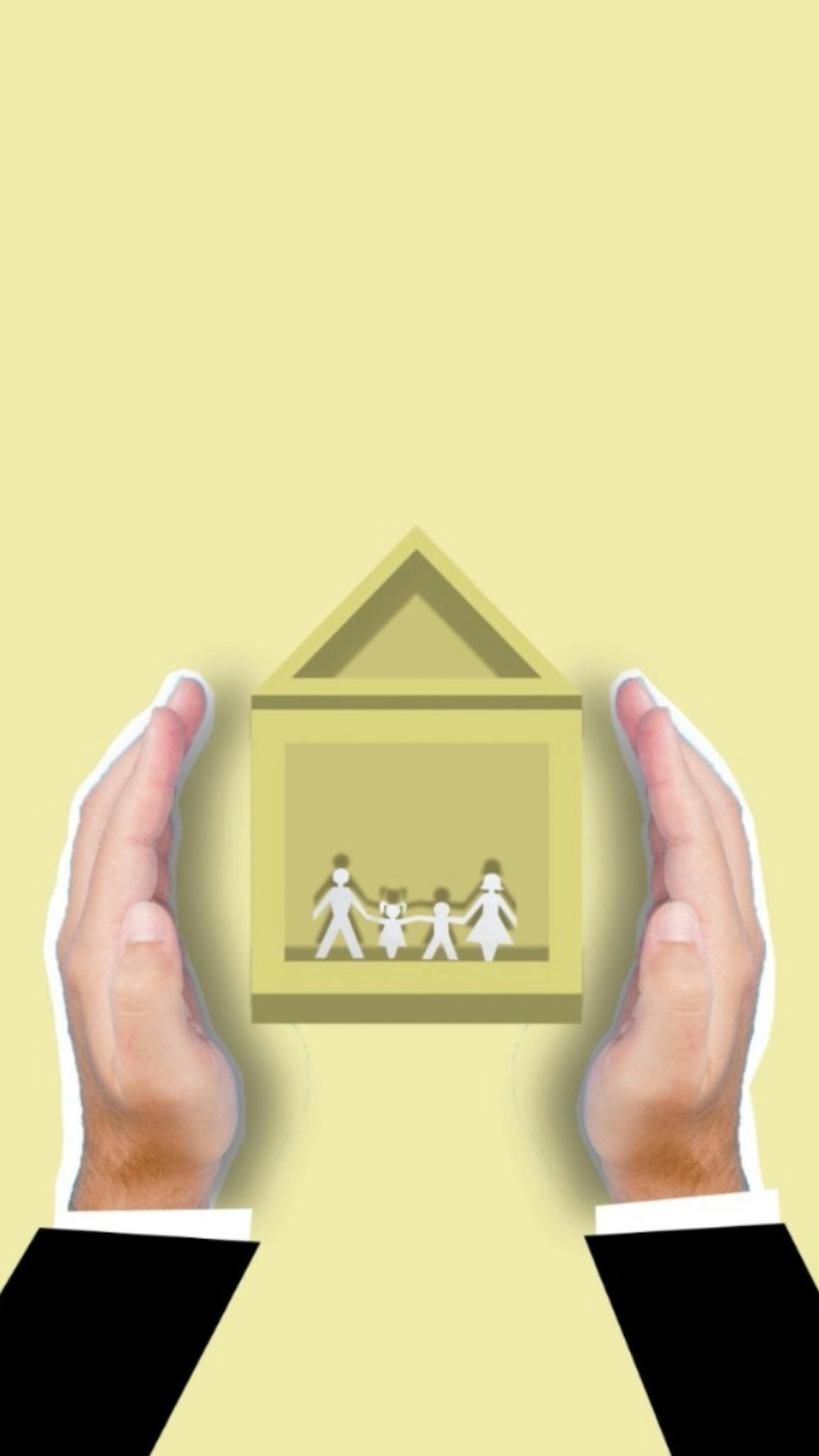 Two hands surrounding a paper cut out family in a block house. 